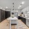 Model kitchen at our apartments for rent in Raleigh, NC, featuring wood grain flooring and a kitchen island.