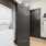 Model laundry closet at our apartments for rent in Raleigh, NC, featuring wood grain floor paneling and in unit laundry.