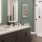 Model bathroom at our apartments for rent in Raleigh, NC, featuring white countertops and black cabinetry.